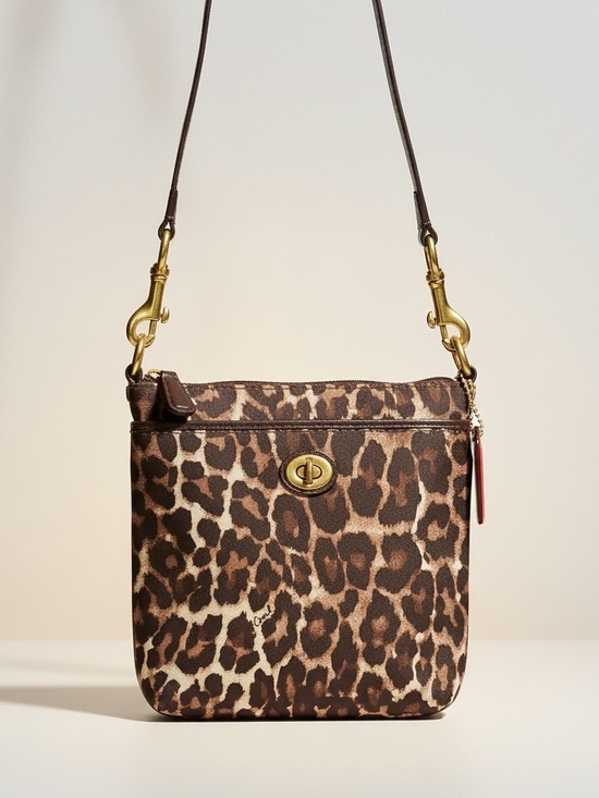 Coach Handbags - Coach Ocelot Leopard Print Crossbody Bag in Canvas with Turnlock Hardware EUC